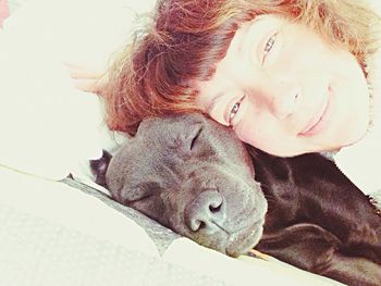 Close-up portrait of smiling young woman lying down