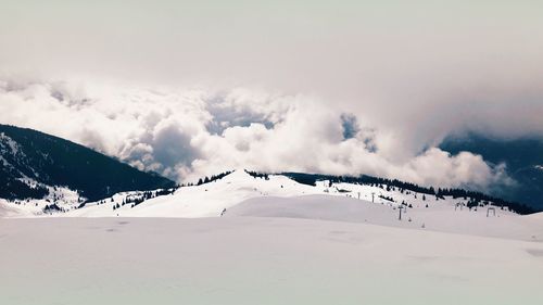 Scenic view of snow covered mountains against sky