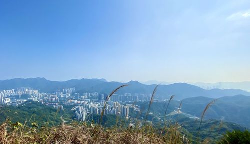 Scenic view of sea and mountains against blue sky