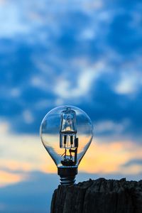 Low angle view of light bulb against sky