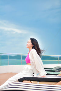 Young woman sitting on boat