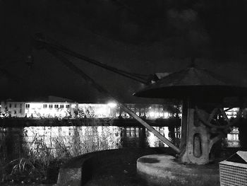 Bridge over river against sky at night