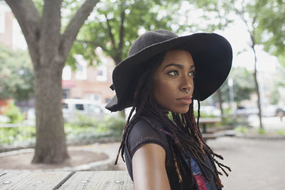 Portrait of young woman looking away outdoors