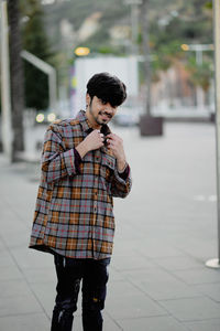 Full length of young man standing in city