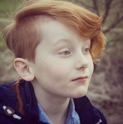 Close-up of cute boy looking away