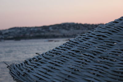 Close-up of sea against sky at sunset