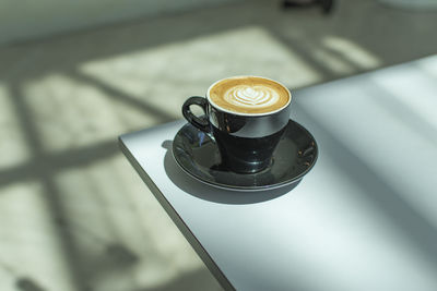 High angle view of coffee cup on table