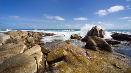 Rocks on beach against sky