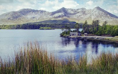  landscape scenery of lake house and mountains  at lough inagh in connemara, galway, ireland