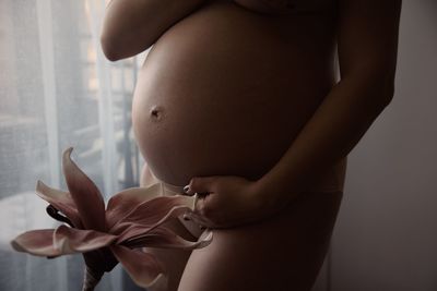 Midsection of woman touching hair