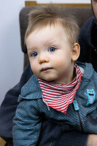 Cute baby boy with a red stripes bib