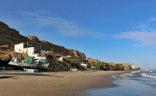 Scenic view of beach against blue sky