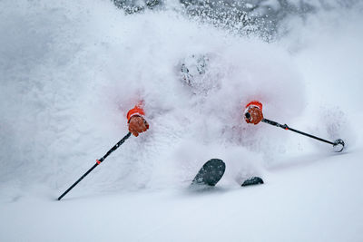 Adult man skiing in deep powder snow in the backcountry, werfenweng, austria.