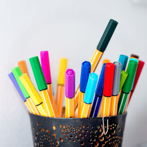 Close-up of colored pencils on white background