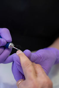 Cropped hand of person holding needle