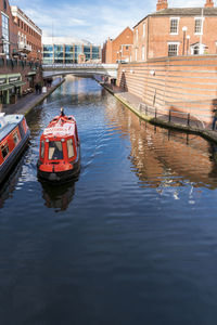 Boat in city against sky