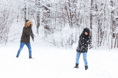 Full length of woman standing on snow covered land