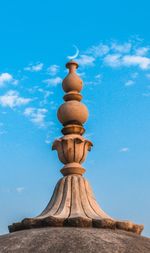 Low angle view of sculpture against blue sky