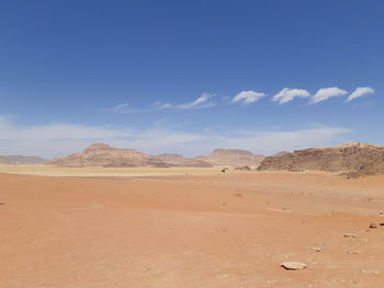 Scenic view of desert against blue sky