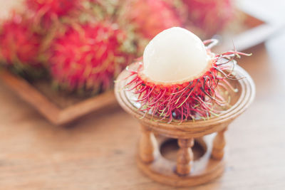 Close-up of rambutans in stand on table