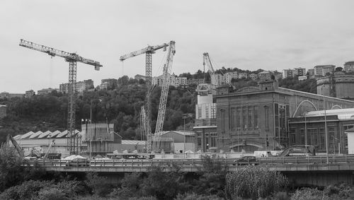 Construction site by buildings against sky