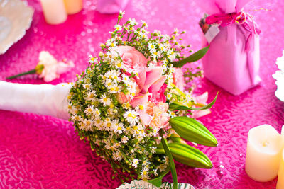 Wedding flower bouquet on a pink table.