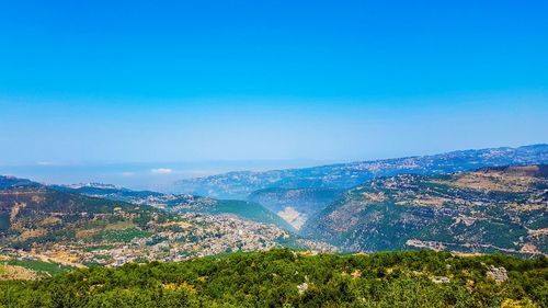 High angle view of landscape against blue sky