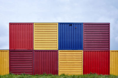 Multi colored cargo containers against sky