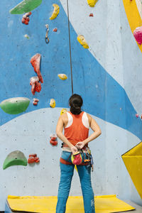 Woman climbing on wall