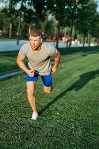 Full length of young man sitting on grass