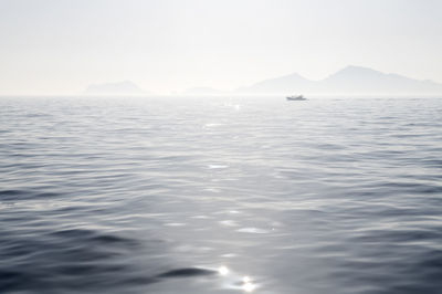 Scenic view of sea and mountains against sky