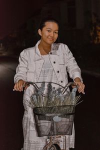 Girl sitting on her bicycle at night