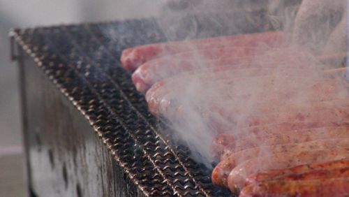 High angle view of sausages cooking on grill