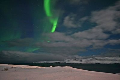 Scenic view of landscape against dramatic sky at night