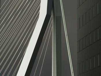 Low angle view of suspension bridge against sky