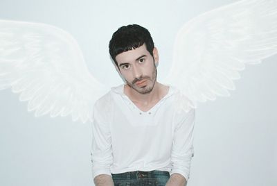 Portrait of young man against white background