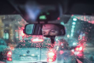 Portrait of man seen through car window