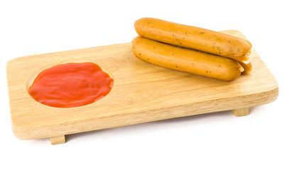 High angle view of bread on cutting board against white background