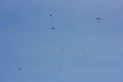 Low angle view of balloons against blue sky