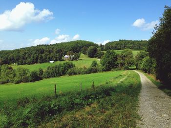 Scenic view of field against cloudy sky