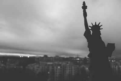 Statue of liberty against cloudy sky