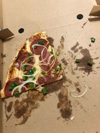 High angle view of pizza on cutting board