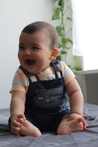 Cute baby boy sitting at home