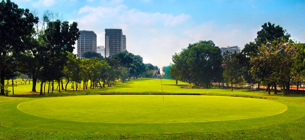 Park in city against sky