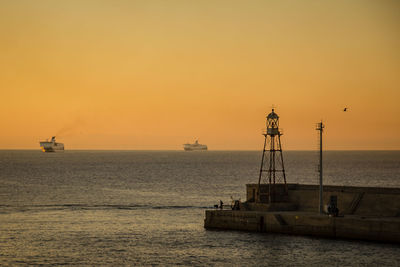 Scenic view of sea against orange sky