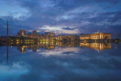 Reflection of illuminated city in water at night