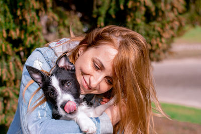 Portrait of a smiling young woman with dog