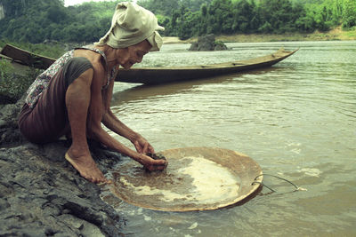 Side view of man working in water