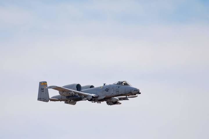 transportation, airplane, mode of transport, air vehicle, low angle view, copy space, travel, sky, flying, clear sky, architecture, building exterior, built structure, outdoors, day, journey, mid-air, no people, on the move, cloud - sky