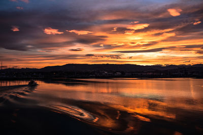 Scenic view of lake against orange sky